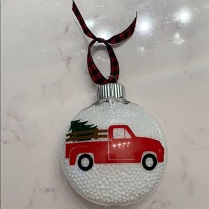 Red truck with Christmas tree snow filled ornament